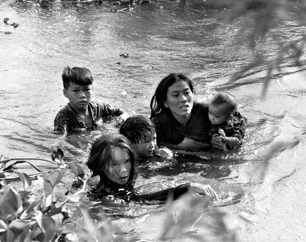 Vietnamese Mother and Children Flee Village Bombing