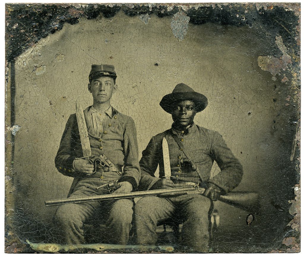 Sergeant A.M. Chandler of the 44th Mississippi Infantry Regiment, Co. F., and Silas Chandler, family slave, with Bowie knives, revolvers, pepper-box, shotgun, and canteen”, between 1861 and 1863