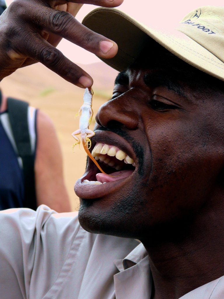 Franz plays with lizard - Sossus Vlei, Namibia